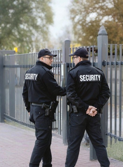 Two security guards patrolling secured gated area